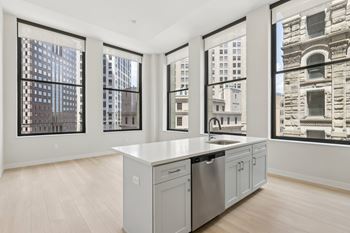 A kitchen with a large island and a dishwasher. at LiveWell Apartments, Pittsburgh, Pennsylvania